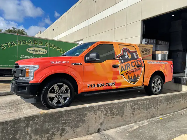 Air City AC and Heating wrapped truck loading at a Houston supply house