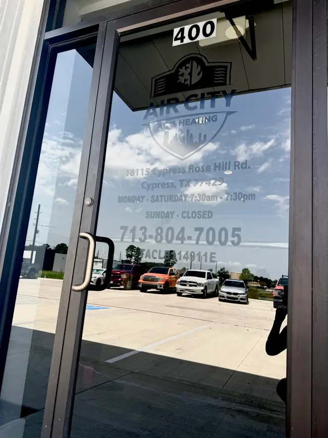 Air City unit door vinyl showing the logo, address, hours and Texas licence
